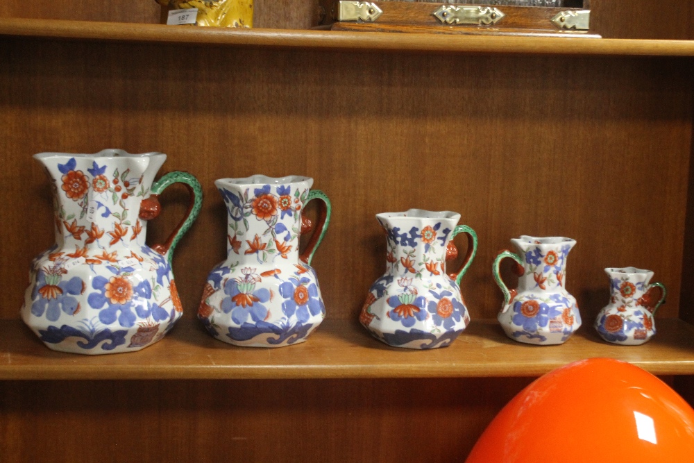 A GRADUATED SET OF FIVE IRONSTONE JUGS¦Condition Report:,/b>The large jug has a hairline crack