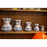 A GRADUATED SET OF FIVE IRONSTONE JUGS¦Condition Report:,/b>The large jug has a hairline crack