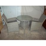 A PAGODA RATTEN GARDEN TABLE SET WITH TWO CHAIRS