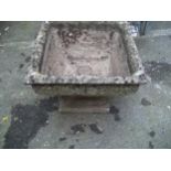 A RECONSTITUTED STONE GARDEN URN PLANTER