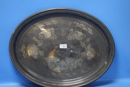 A WHITE METAL OVAL TRAY