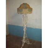 AN ANTIQUE WROUGHT IRON FLOOR STANDING STANDARD LAMP