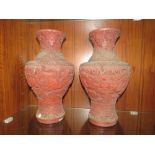 A PAIR OF LARGE ORIENTAL CINNABAR BALUSTER VASES, DECORATED WITH FIGURES PLAYING BOARD GAMES, H 38