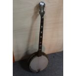 A VINTAGE WOODEN BANJO, WITH LOSSES