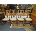 A SET OF FOUR OAK DINING CHAIRS WITH DROP IN UPHOLSTERED SEATS