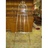 A SILVER EFFECT EASEL, WITH ADJUSTABLE PICTURE LEDGE, HEIGHT WHEN FULLY EXTENDED APPROX 168 CM