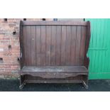 A LARGE HIGH BACKED SETTLE, H 181 CM, W 183 CM - A/F WITH NUMEROUS WORM HOLES
