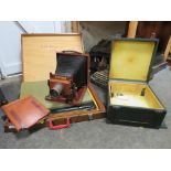 A CASED ANTIQUE PLATE CAMERA - CONTENTS NOT CHECKED, TOGETHER WITH A WOODEN CASE OF BLACK AND