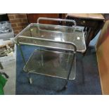 A VINTAGE RETRO STYLE CHROME AND GLASS DRINKS TROLLEY
