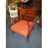AN ANTIQUE ADJUSTABLE RECLINING CHAIR WITH LATER CUSHION