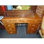 A VINTAGE UTILITY / RETRO STYLE SMALL OAK DESK, H 76 CM, W 110 CM, TOGETHER WITH AN OAK WALL SHELF