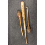 A PAIR OF VINTAGE OAK JUGGLERS CLUBS TOGETHER WITH A LOUISVILLE SLUGGER FLAME TEMPERED BASEBALL BAT