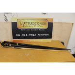 A VINTAGE CORK HANDLED SNOOKER CUE BY BURROUGHS AND WATTS LTD OF LONDON, IN METAL CARRY CASE,