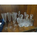 A QUANTITY OF GLASSWARE TO INCLUDE DECANTERS AND CHAMPAGNE FLUTES