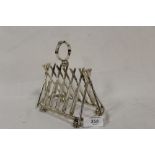 A SILVER PLATED NOVELTY CRICKET THEMED SIX DIVISION TOAST RACK