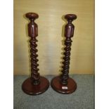 A PAIR OF TALL MAHOGANY BARLEY TWIST CANDLE STICKS, HEIGHT 52 CM