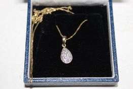 A 9CT GOLD PENDANT AND CHAIN NECKLACE SET WITH 0.15 CARATS OF DIAMONDS