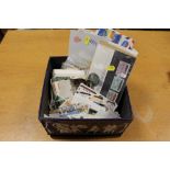 A TIN OF ASSORTED STAMPS AND FIRST DAY COVERS