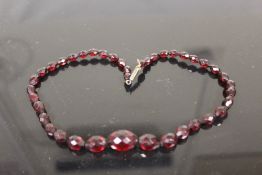 A VINTAGE CHERRY AMBER BEAD NECKLACE