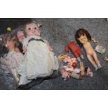 THREE SMALL VINTAGE DOLLS, A BAG OF VINTAGE MINIATURE TOY DOLLS AND A VINTAGE ROLLER EYE DOLL MARKED