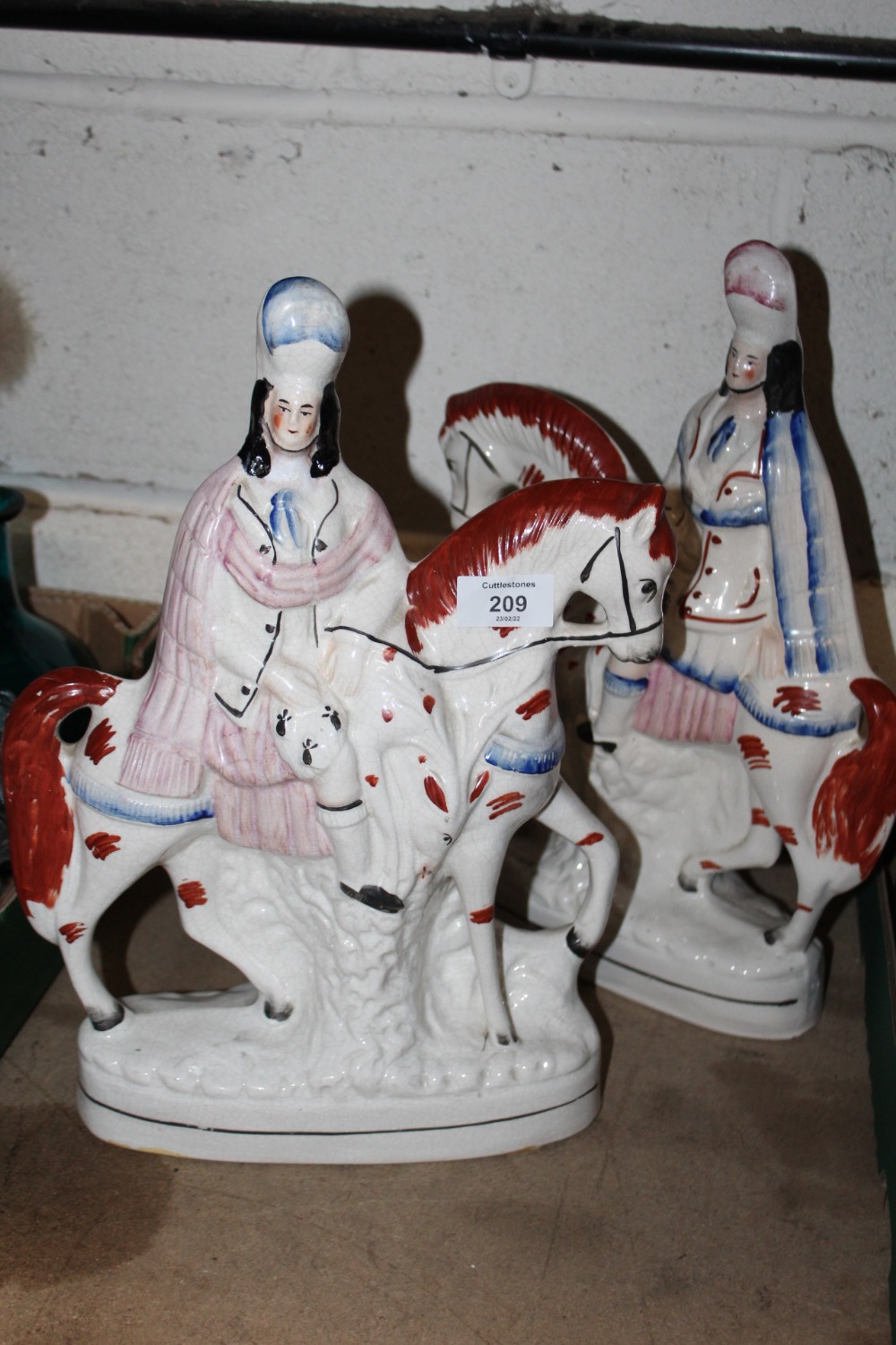 A PAIR OF STAFFORDSHIRE STYLE FLATBACK FIGURES ON HORSEBACK