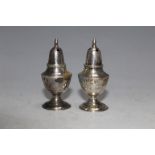 A PAIR OF ANTIQUE SILVER PEPPERS - HONK KONG SILVER MARKS