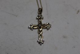 A 9CT GOLD CRUCIFIX AND CHAIN SET WITH 0.25 CARATS OF DIAMONDS