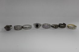 FOUR SILVER DRESS RINGS TOGETHER WITH FOUR UNMARKED DRESS RINGS (8)