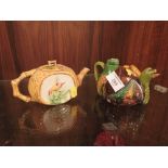 AN UNUSUAL MAJOLICA DRAGON SHAPED TEAPOT TOGETHER WITH ANOTHER, BOTH WITH CHIPS TO LIDS
