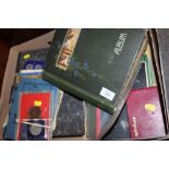 A VINTAGE POSTCARD ALBUM TOGETHER WITH THREE STAMP ALBUMS, COLLECTABLE TOKENS ETC.ªAND FOUR STAMP