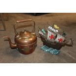 AN EASTERN STYLE COPPER AND BRASS KETTLE TOGETHER WITH A CAST METAL GALLEON SHAPED DOOR STOP