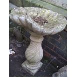 A LARGE HEAVY SHELL STYLE CONCRETE BIRD BATH