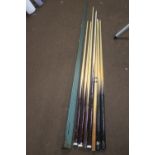 A COLLECTION OF ASSORTED POOL AND SNOOKER CUES, MOST MISSING TIPS