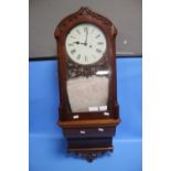 AN ANTIQUE MAHOGANY WALL CLOCK WITH WINDER