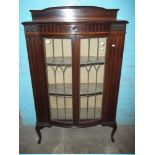 AN ANTIQUE BOW FRONTED LEADED DISPLAY CABINET WITH CABRIOLE LEGS