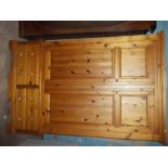 A SOLID PINE DOUBLE WARDROBE WITH FOUR DRAWERS