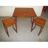 A RETRO TEAK NEST OF THREE TABLES