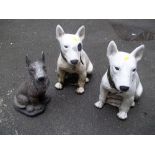 THREE CONCRETE DOG STATUES