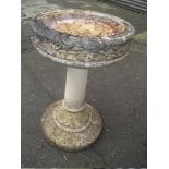 A LARGE CONCRETE HEAVY BIRD BATH