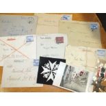 A WW2 GERMAN CROSS STYLE MEDAL TOGETHER A COLLECTION OF WW2 GERMAN CORRESPONDENCE ENVELOPES ETC