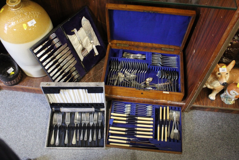 AN OAK CASED CANTEEN OF CUTLERY TOGETHER WITH TWO OTHER CUTLERY SETS