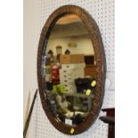 AN ARTS AND CRAFTS STYLE COPPER FRAMED OVAL WALL MIRROR OVERALL SIZE - 61CM X 41CM