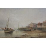 A GILT FRAMED AND GLAZED WATERCOLOUR OF A BEACH SCENE WITH MOORED BOATS SIGNED E J BLADON? LOWER