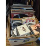 A BOX OF LP RECORDS, 7" SINGLES AND CDS ETC. TO INCLUDE GLEN MILLER, ELVIS ETC.