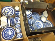 TWO BOXES OF BLUE AND WHITE WILLOW PATTERN CHINA TO INCLUDE A TEAPOT, CUPS AND SAUCERS ETC