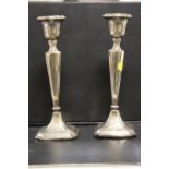 A MATCHED PAIR OF FILLED HALLMARKED SILVER CANDLESTICKS A/F