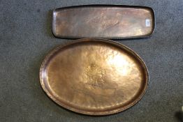 TWO LARGE ARTS AND CRAFTS COPPER TRAYS BY HUGH WALLIS, the larger tray of oval form with central
