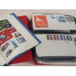 AN ALBUM OF FIRST DAY COVERS TOGETHER WITH A STAMP ALBUM