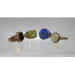 A COLLECTION OF FOUR MIDDLE EASTERN INTAGLIO YELLOW METAL RINGS