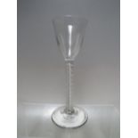 AN 18TH CENTURY GEORGIAN WINE GLASS WITH AIR TWIST STEM, conical foot and snapped pontil, H 15.7 cm